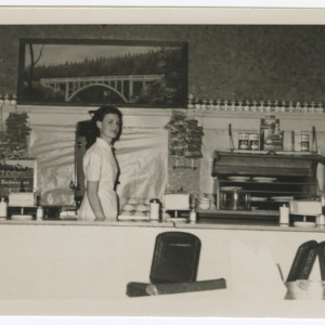 Woman behind café counter
