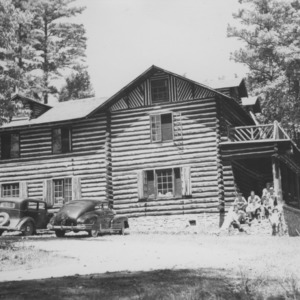 Group on porch of log house