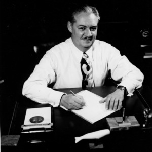 Dean Malcolm E. Campbell at desk