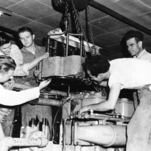 Researchers removing cylander head from American Locomotive 539-Type diesel engine