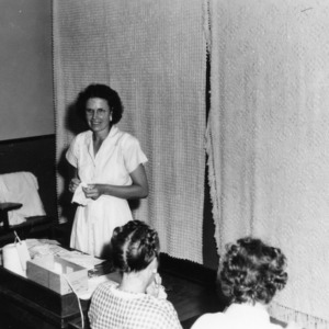 Mrs. Garland King instructing candle wicking during Farm and Home