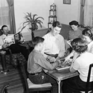 Family playing games in home