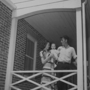 Family with baby on porch