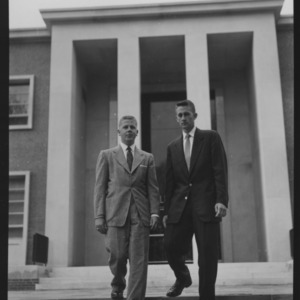 Two college men in front of library, April 1954
