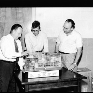 Nuclear Power Development- Short Course; Three Men Examining Fast Breeder Reactor