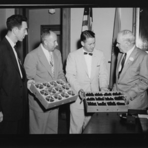 Presentation of Dew Berries to Governor; Left to right: Don Farris, Extension Fruit and Vegetable Marketing Specialist; Mel Kolbe, Extension Fruit Specialist; Ben C. Boney, Assistant Farm Agent in Marketing; Luther Hodges