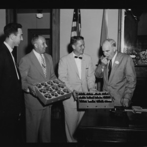 Presentation of Dew Berries to Governor; Left to right: Don Farris, Extension Fruit and Vegetable Marketing Specialist; Mel Kolbe, Extension Fruit Specialist; Ben C. Boney, Assistant Farm Agent in Marketing; Luther Hodges