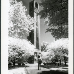 Student standing in front of Memorial Bell Tower, 1956