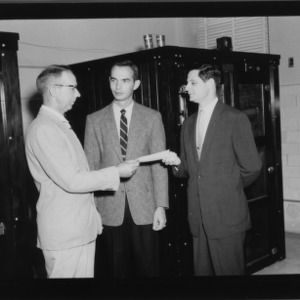 Bundy Belk Presenting $1000 check to Dr. H. L. Bumgardner and Dr. Gloyener