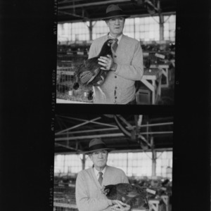 Mr. C.J. Maupin holding chicken at State Fair