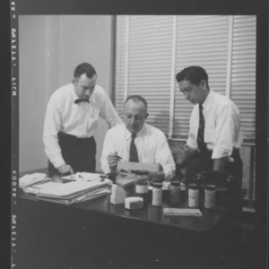 Dr. William C. Bell and others with ceramic specimens