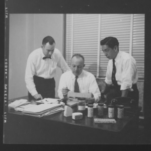 Dr. William C. Bell and others with ceramic specimens
