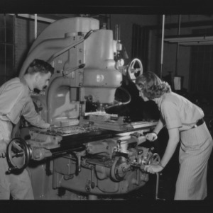Doris Lee Garcia, first woman to receive a bachelor's in industrial engineering, and other working machinery in lab