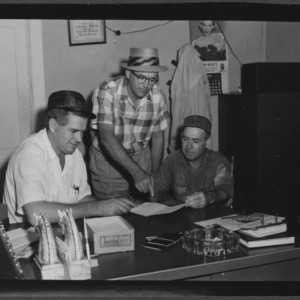 Carteret County men at desk