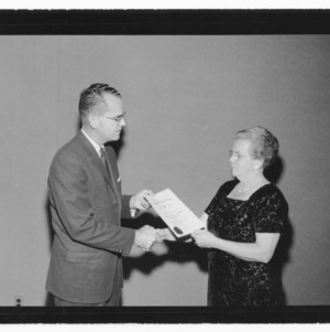Woman receiving certificate Gamma Sigma Delta Honors Banquet