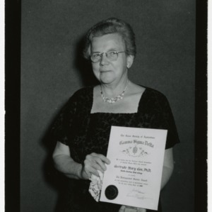 Gertrude Cox with certificate at Gamma Sigma Delta Honors Banquet