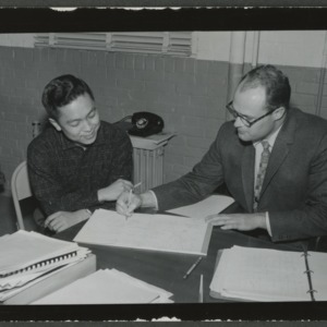 W. O. Daggett and student at desk