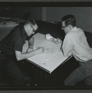Two men at drafting table