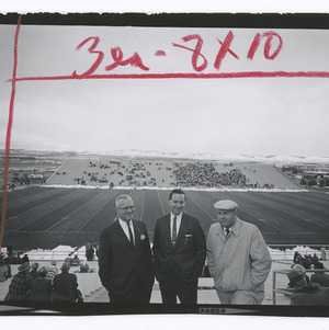 Men posing for photo with football field in background in Laramie, WY