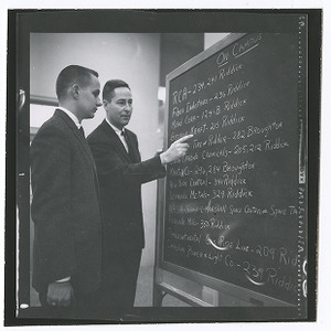 Bill Simpson and student looking at chalkboard