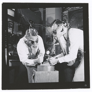 Two men working with plasma research equipment