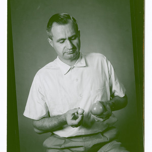 Dr. Warren Henderson holding tomatoes